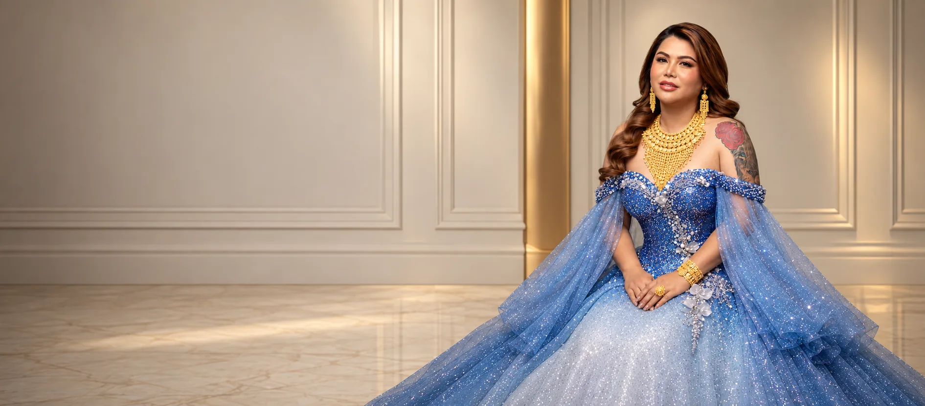 Misskim model in a gold gown wearing a 21K necklace, bangles and ring